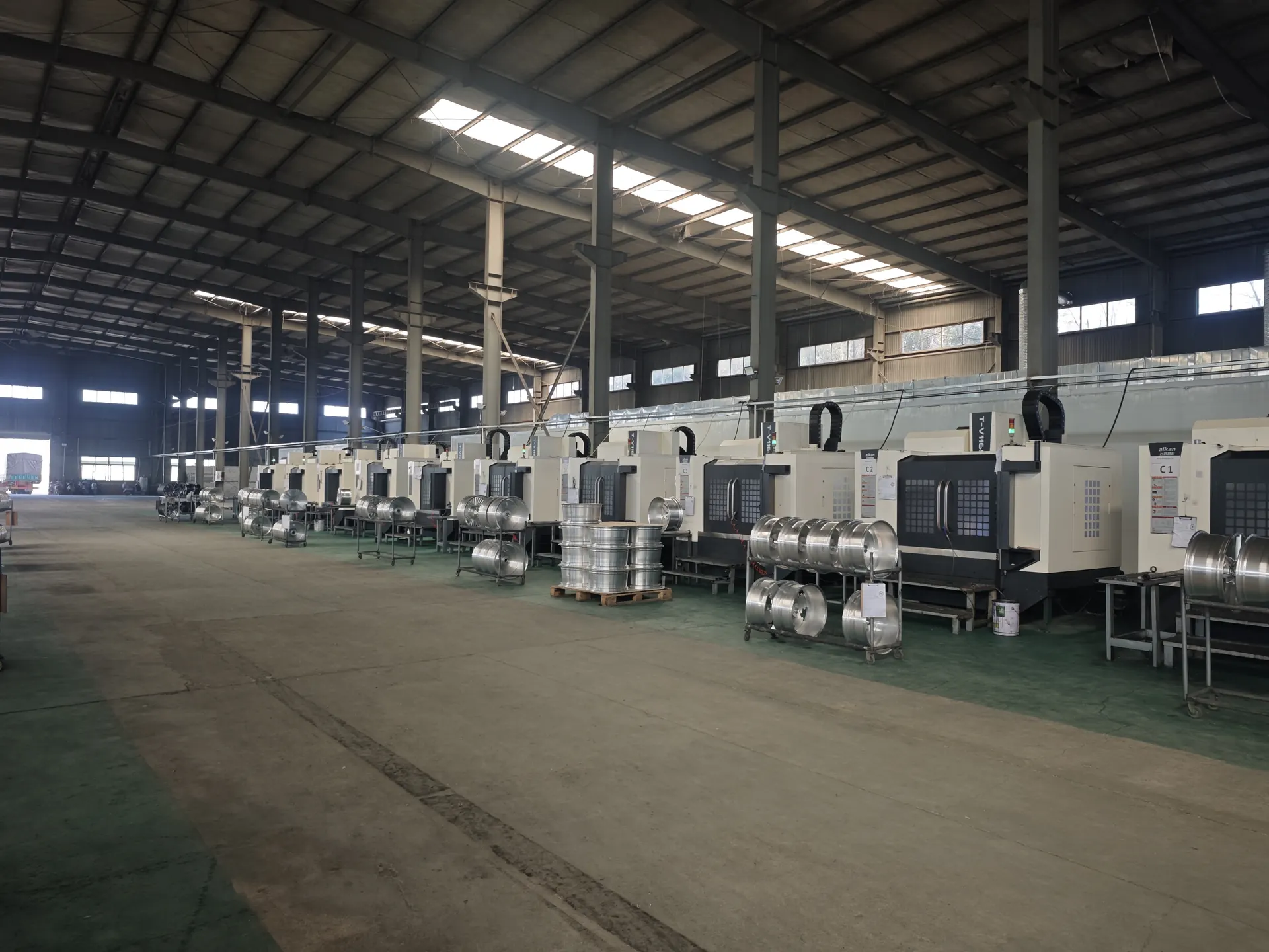 Forged wheel manufacturing factory floor with CNC equipment