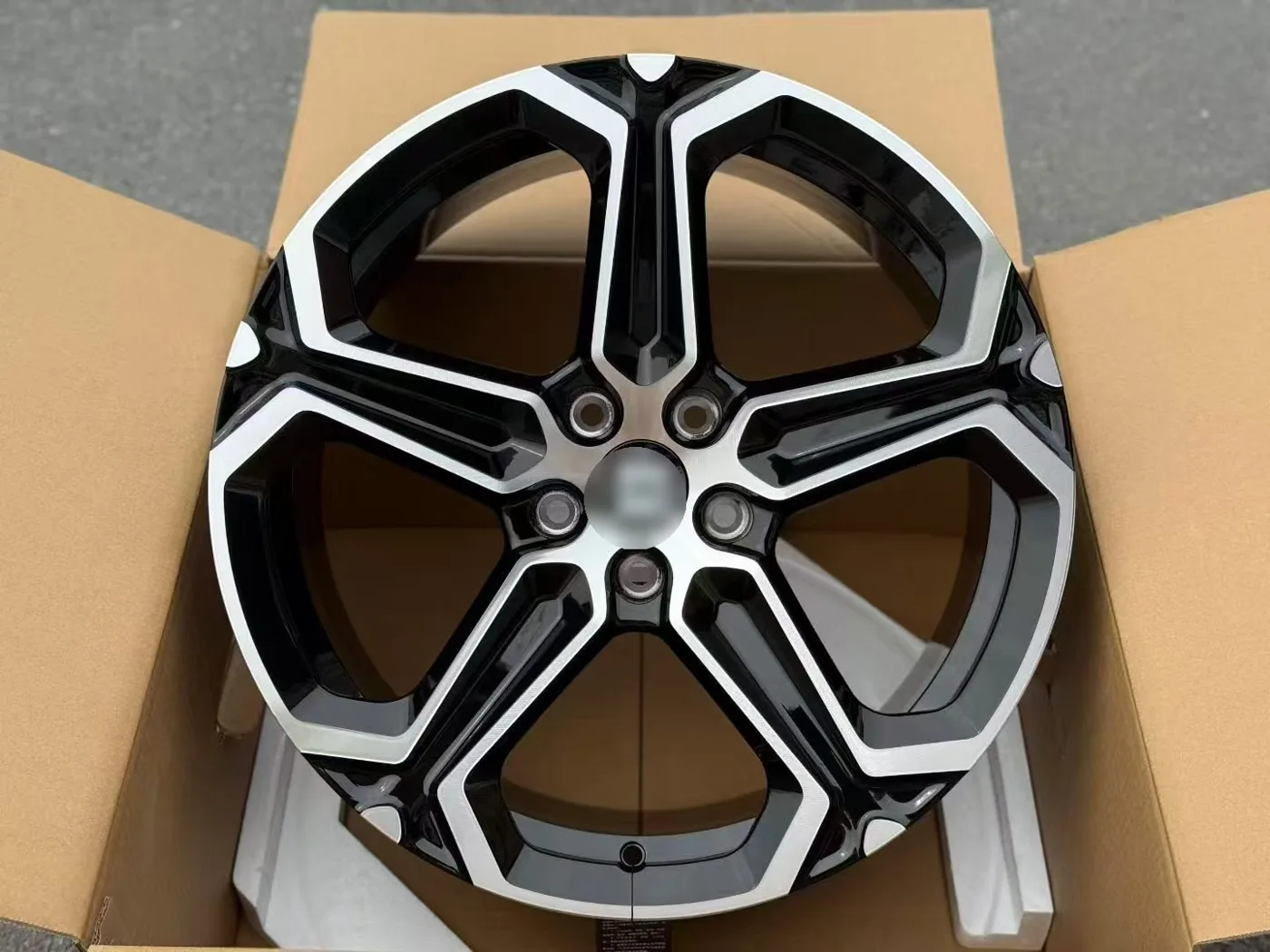 Black machined 5-spoke EV wheel in export carton